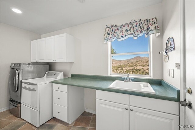 laundry area with washer and dryer, cabinet space, and a sink