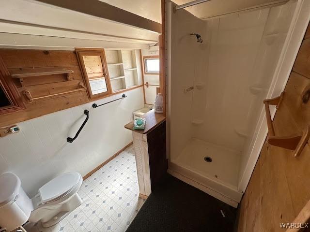 full bath featuring walk in shower, toilet, and tile patterned floors