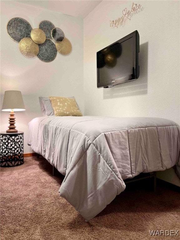 bedroom featuring carpet and baseboards