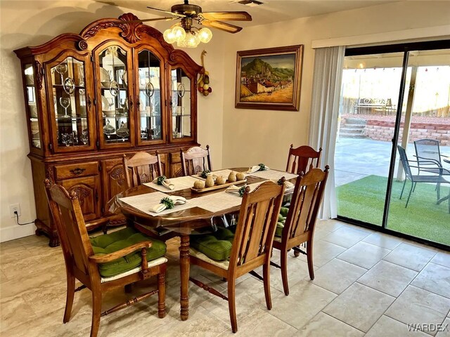 dining space featuring a ceiling fan and light tile patterned floors