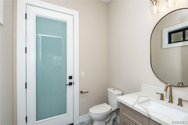 half bathroom with toilet and vanity