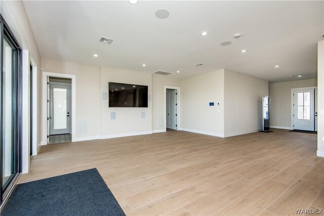 unfurnished living room with baseboards, recessed lighting, visible vents, and light wood-style floors