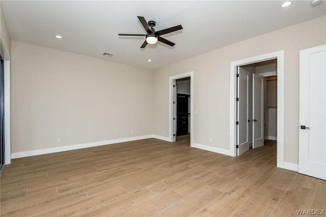 unfurnished bedroom featuring light wood finished floors, baseboards, visible vents, and recessed lighting