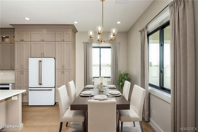 dining area featuring light wood-type flooring, an inviting chandelier, and recessed lighting