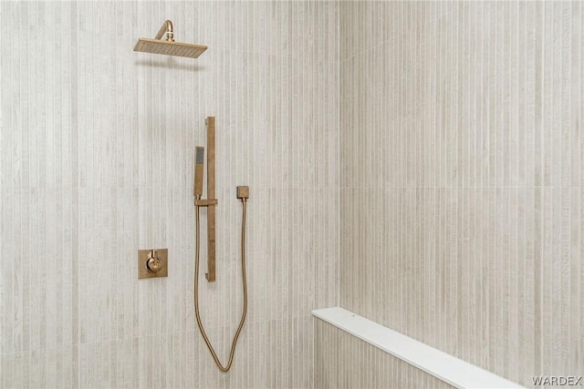 interior details featuring a tile shower