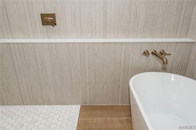 bathroom with a soaking tub