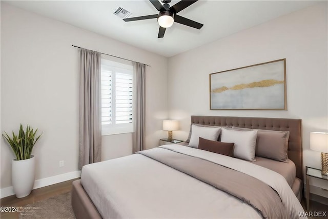 bedroom featuring ceiling fan, baseboards, visible vents, and dark wood finished floors