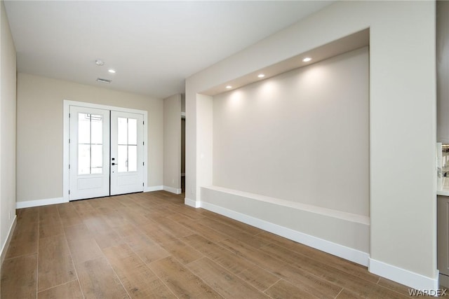 entrance foyer featuring visible vents, baseboards, french doors, light wood-style floors, and recessed lighting