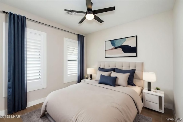 bedroom featuring a ceiling fan, visible vents, and baseboards