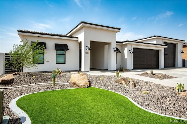 2376 E La Mancha, Fort Mohave, AZ 86426 - modern home featuring concrete driveway, a front lawn, an attached garage, and stucco siding