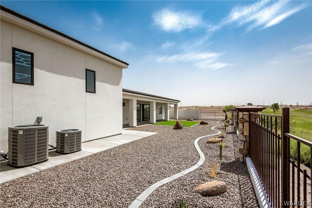 view of yard with a fenced backyard and central AC unit