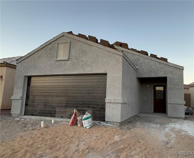 view of front of house featuring an attached garage and stucco siding