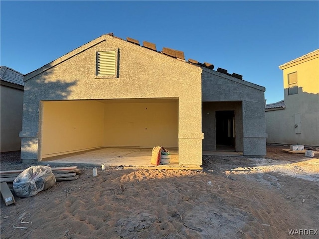 view of front of house with a garage and stucco siding