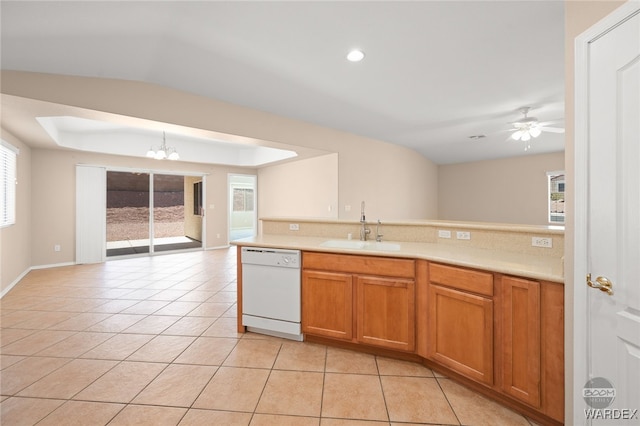 kitchen with light tile patterned floors, a sink, open floor plan, light countertops, and dishwasher