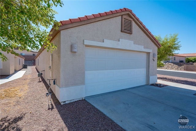 garage with concrete driveway