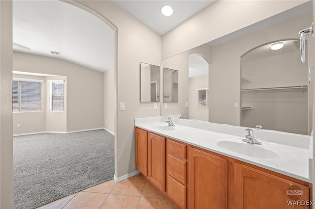 bathroom featuring double vanity, tile patterned flooring, a sink, and visible vents