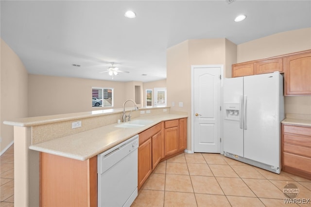 kitchen featuring white appliances, light countertops, a sink, and light tile patterned floors