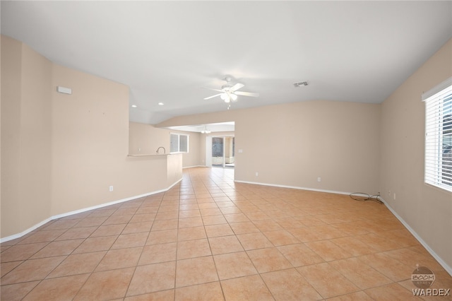 unfurnished room featuring a ceiling fan, visible vents, baseboards, and light tile patterned flooring