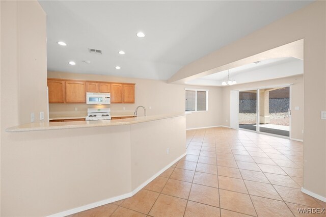 2460 Topanga Dr, Bullhead City, AZ 86442 - kitchen with white appliances, a chandelier, baseboards, recessed lighting, and light countertops