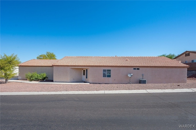 2460 Topanga Dr, Bullhead City, AZ 86442 - ranch-style house with stucco siding, a tile roof, and central AC unit