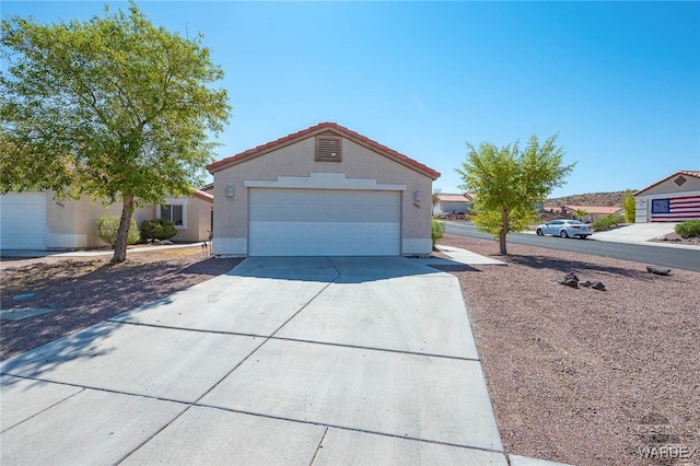 ranch-style home with driveway, a tiled roof, and stucco siding