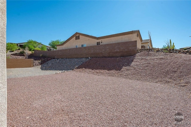 view of home's exterior featuring fence and stucco siding