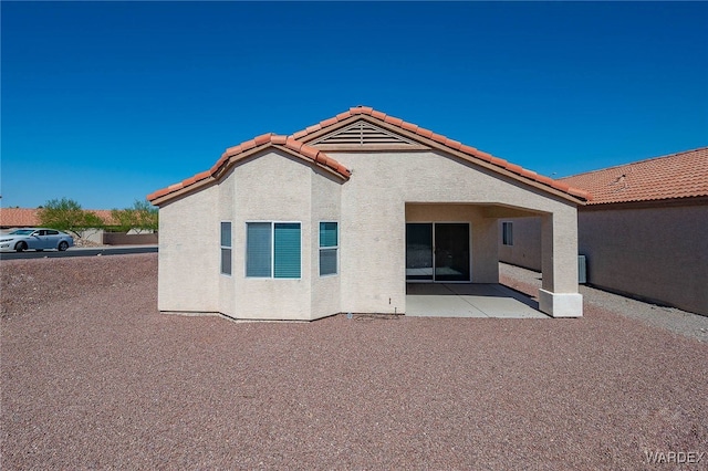 2460 Topanga Dr, Bullhead City, AZ 86442 - rear view of property with a tiled roof, stucco siding, and a patio
