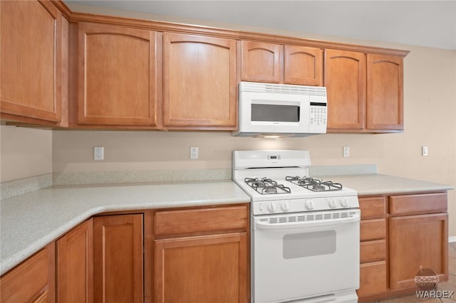 kitchen with light countertops and white appliances