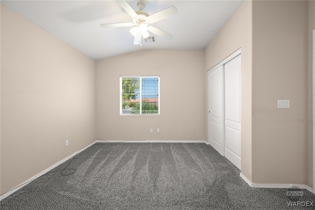 unfurnished bedroom featuring visible vents, baseboards, vaulted ceiling, a closet, and carpet