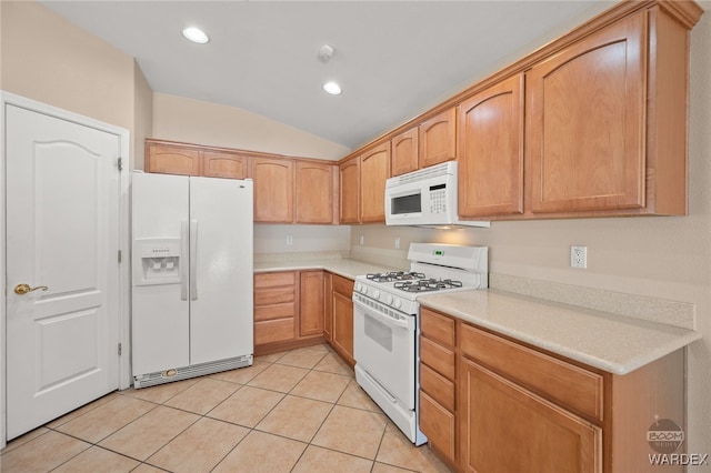 kitchen with light tile patterned floors, lofted ceiling, recessed lighting, white appliances, and light countertops