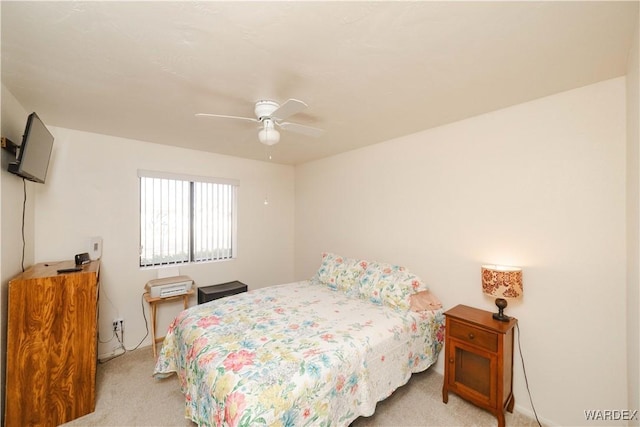 bedroom featuring light carpet and ceiling fan