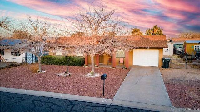 single story home with a garage, driveway, fence, and stucco siding