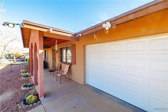 garage featuring concrete driveway