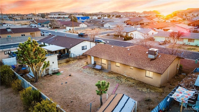 aerial view at dusk featuring a residential view