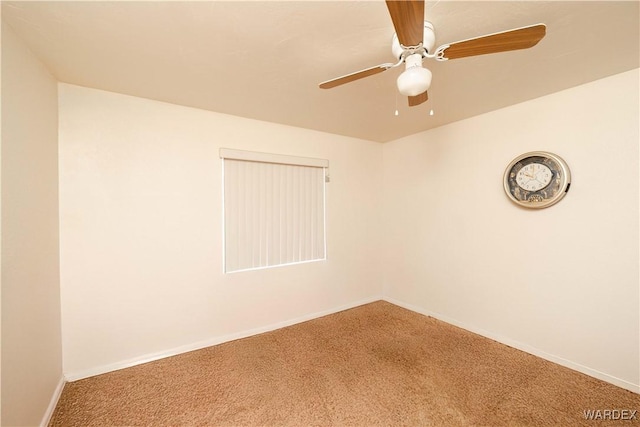 unfurnished room with carpet floors, baseboards, and a ceiling fan