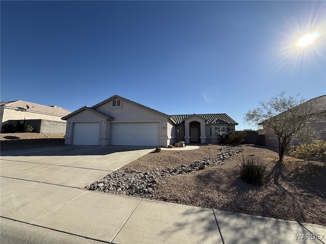 single story home with a garage, driveway, and stucco siding