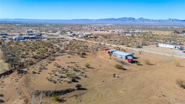 aerial view featuring a desert view and a mountain view