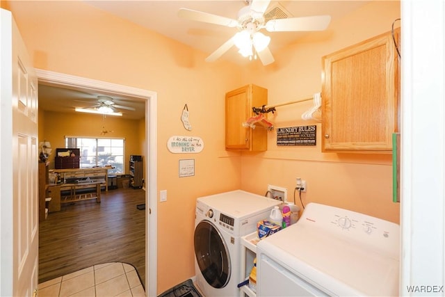 laundry room featuring a ceiling fan, washing machine and dryer, cabinet space, and light tile patterned flooring