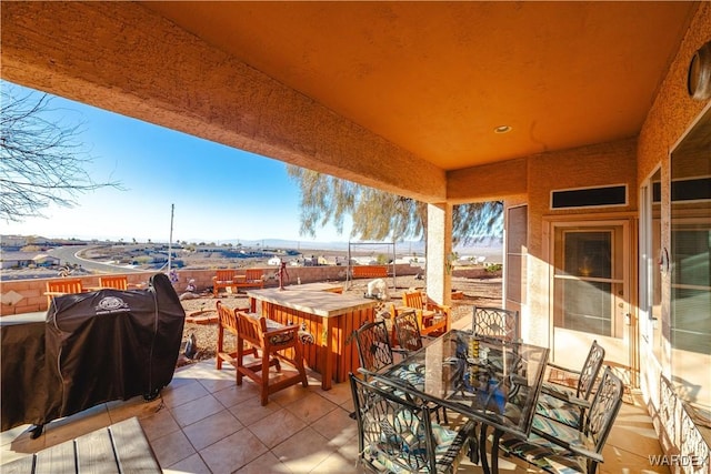 view of patio with area for grilling and outdoor dining space