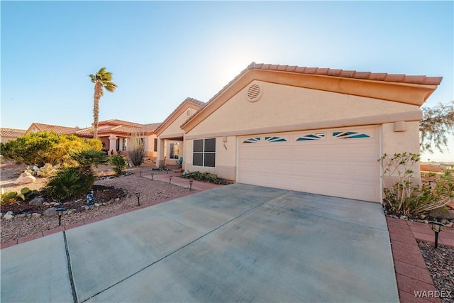 view of front of property with a garage, concrete driveway, and stucco siding