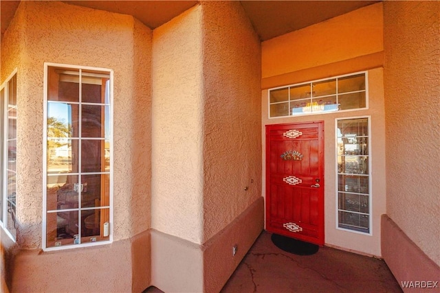 doorway to property featuring stucco siding