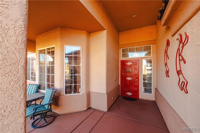 entrance to property with stucco siding