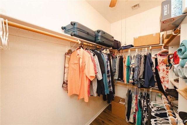 spacious closet featuring ceiling fan, wood finished floors, visible vents, and lofted ceiling