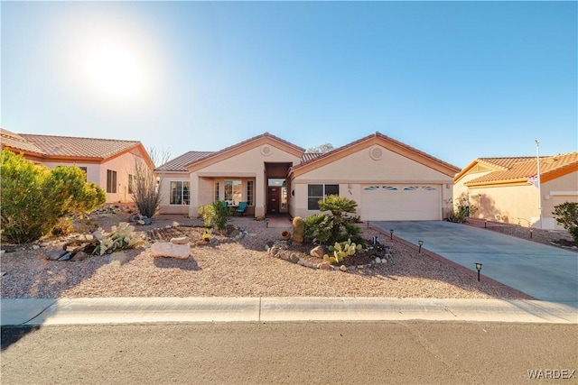 view of front of house with concrete driveway, an attached garage, and stucco siding