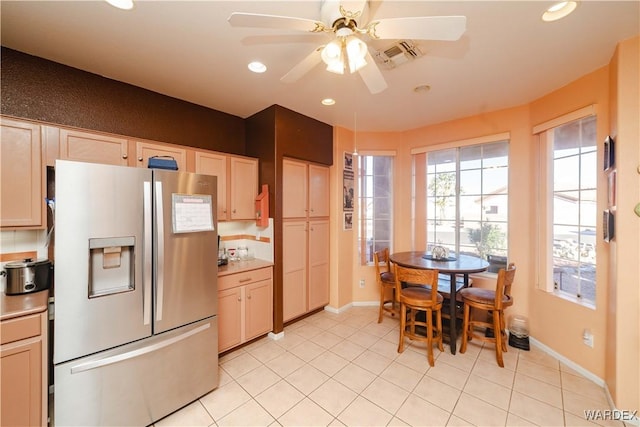 kitchen with visible vents, stainless steel fridge with ice dispenser, light countertops, light brown cabinets, and recessed lighting