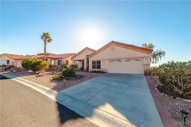 view of front facade with an attached garage, driveway, and stucco siding