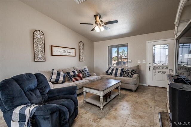 living area featuring ceiling fan and lofted ceiling