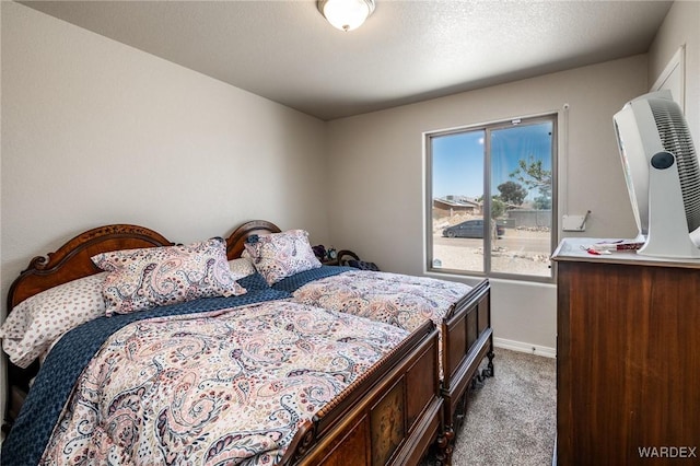 bedroom featuring baseboards and carpet