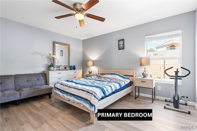 bedroom with ceiling fan, light wood-type flooring, and baseboards