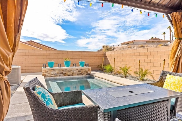 view of swimming pool featuring central AC and a fenced backyard